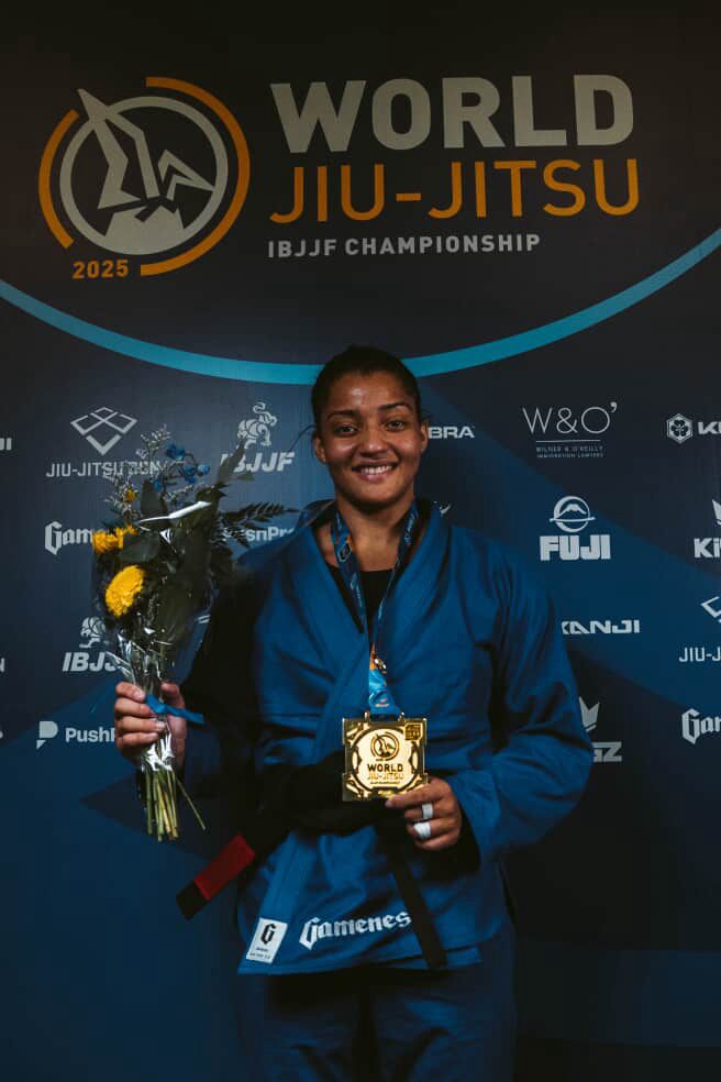Elementum athlete holding a gold medal and flowers at the IBJJF World Championship 2025