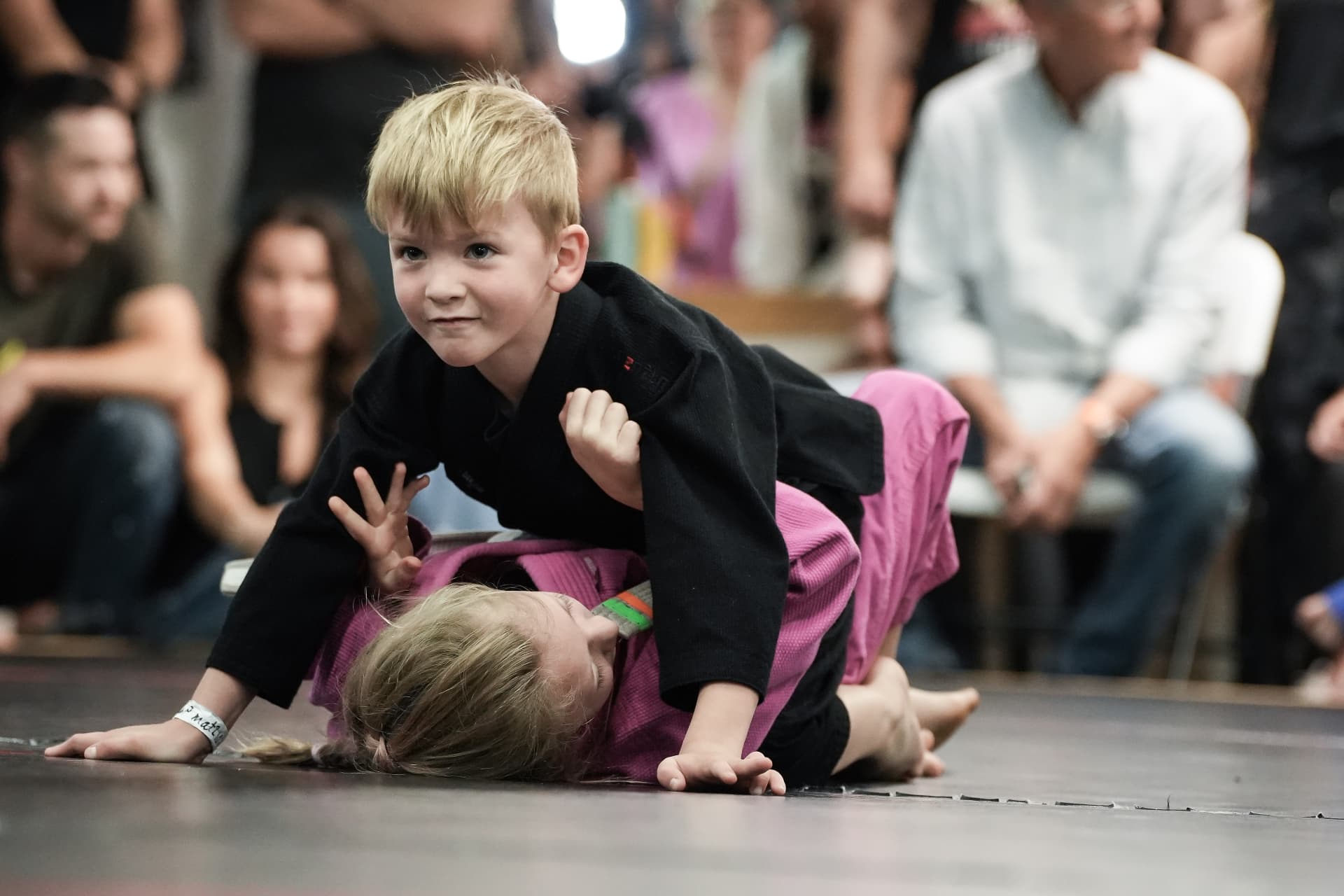 Two young students training in front of family and friends