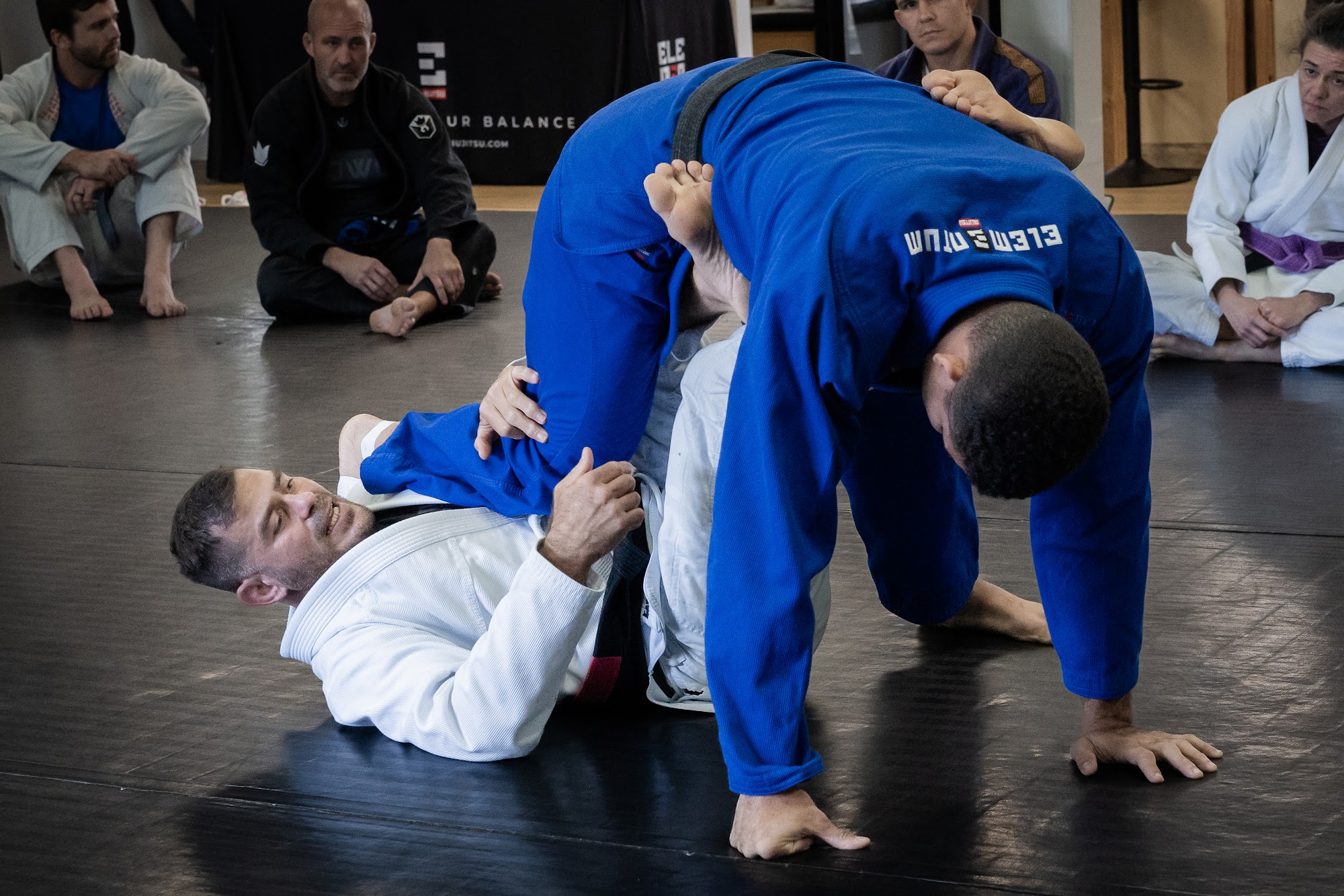 Brazilian Jiu-Jitsu practitioners training together on the mats at Elementum